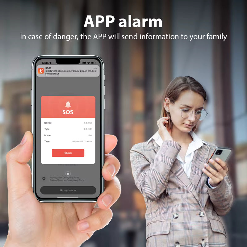Person holding a smartphone with an app alarm screen, showing a woman using the phone in the background.